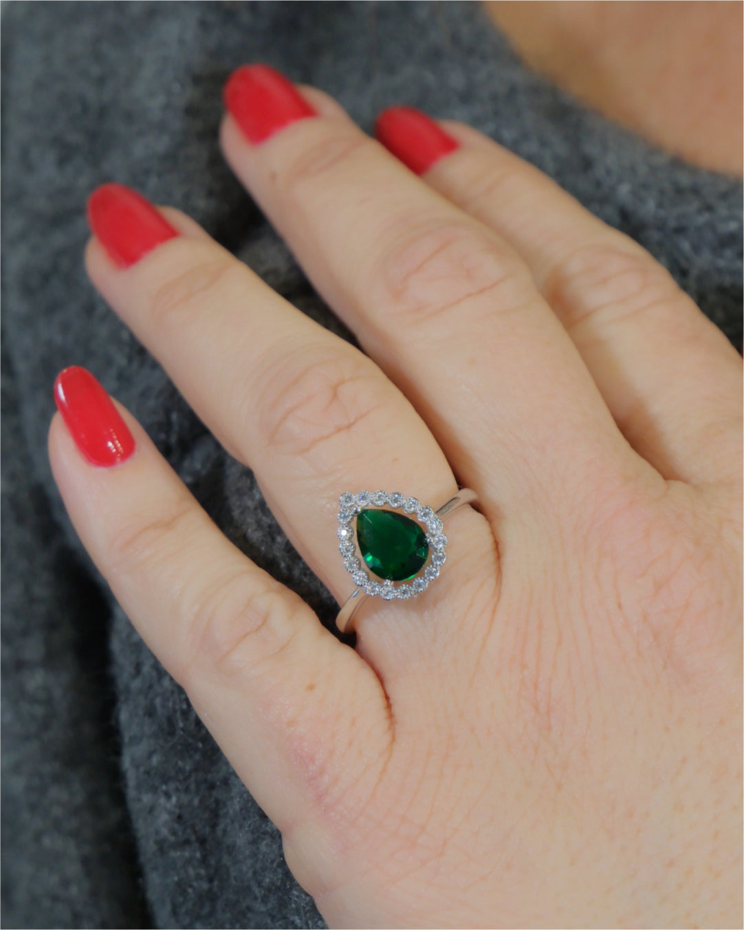 Anillo con centro color esmeralda y orla alrededor