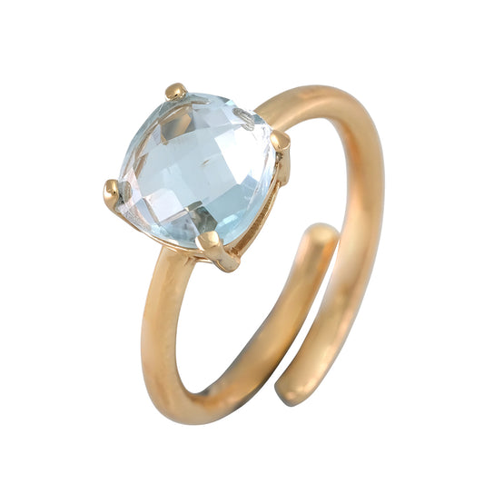 Anillo con baño de oro y topacio azul central